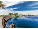 Scenic lake view featuring waterfront living, lush landscaping, and community amenities under a bright blue sky at 21610 N Bradford Dr, Maricopa, AZ 85138