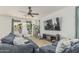 Spacious living room boasts cozy seating, natural light, and a ceiling fan at 21610 N Bradford Dr, Maricopa, AZ 85138