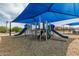 Modern community playground with slides, climbing features, and shaded areas for children to safely enjoy outdoor play at 21610 N Bradford Dr, Maricopa, AZ 85138