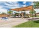 Community playground with shaded play structures, and seating at 21610 N Bradford Dr, Maricopa, AZ 85138