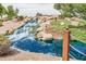 Beautiful community waterfall feature with rocks, plants, and sparkling blue water at 21610 N Bradford Dr, Maricopa, AZ 85138
