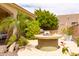 Outdoor living area with a built-in fire pit and lush landscaping to create a serene and relaxing atmosphere at 2203 E Tonto Pl, Chandler, AZ 85249