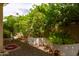 A shady backyard corner has lush greenery and a lattice fence offering a secluded outdoor space at 2203 E Tonto Pl, Chandler, AZ 85249