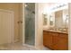 Modern bathroom featuring a glass-enclosed shower, marble floors, and a vanity with wood cabinets at 2203 E Tonto Pl, Chandler, AZ 85249