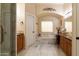 Bathroom boasting marble floors, a large soaking tub, and dual vanities with natural wood cabinets at 2203 E Tonto Pl, Chandler, AZ 85249