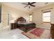 Spacious bedroom featuring marble floors, a ceiling fan, and natural light from two windows at 2203 E Tonto Pl, Chandler, AZ 85249
