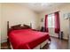 Cozy bedroom with hardwood floors, natural light and red accents at 2203 E Tonto Pl, Chandler, AZ 85249