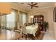 Comfortable dining area adjacent to kitchen featuring a china hutch and chandelier with a ceiling fan at 2203 E Tonto Pl, Chandler, AZ 85249