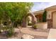 Charming home exterior with a stone archway, lush landscaping, and a welcoming entrance creating a warm curb appeal at 2203 E Tonto Pl, Chandler, AZ 85249