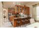 Elegant eat-in kitchen featuring breakfast bar, granite countertops, stainless appliances, and wood cabinetry at 2203 E Tonto Pl, Chandler, AZ 85249