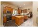 Spacious kitchen featuring custom wood cabinetry, a butcher block island and stainless steel appliances at 2203 E Tonto Pl, Chandler, AZ 85249