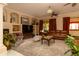 A spacious living room featuring a fireplace, built-ins, and comfortable seating at 2203 E Tonto Pl, Chandler, AZ 85249