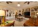 Spacious living room with ceiling fans, stone fireplace, and ample seating at 2203 E Tonto Pl, Chandler, AZ 85249