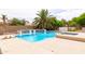 Inviting backyard oasis featuring a pool, spa, lush landscaping, and plenty of space for entertaining at 2203 E Tonto Pl, Chandler, AZ 85249