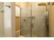 Modern shower with marble surround and frameless glass doors and rainfall showerhead at 2203 E Tonto Pl, Chandler, AZ 85249