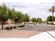 Attractive entrance to a gated community with mature trees and well-maintained landscaping at 2203 E Tonto Pl, Chandler, AZ 85249