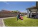 The backyard features a play area, artificial grass, and barbecue perfect for Gathering entertainment and outdoor cooking at 22463 E Desert Spoon Dr, Queen Creek, AZ 85142
