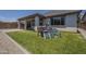 A Gathering-friendly backyard with artificial grass complemented by a cute playset encourages outdoor activity at 22463 E Desert Spoon Dr, Queen Creek, AZ 85142