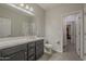 Bright bathroom with double sinks, gray cabinetry, and a large mirror at 22463 E Desert Spoon Dr, Queen Creek, AZ 85142