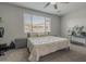 A bedroom featuring a ceiling fan, window with blinds, gray nightstands and carpet at 22463 E Desert Spoon Dr, Queen Creek, AZ 85142