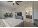 A bedroom showcasing an ensuite bathroom, ceiling fan and view of bed and dresser at 22463 E Desert Spoon Dr, Queen Creek, AZ 85142