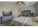 A bedroom with carpet, a ceiling fan, a window with blinds, and gray dresser at 22463 E Desert Spoon Dr, Queen Creek, AZ 85142