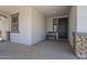 Covered front porch featuring decorative stone pillars, a bench, and a charming welcome mat at 22463 E Desert Spoon Dr, Queen Creek, AZ 85142