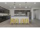 Stylish kitchen island with granite countertops, seating, and modern pendant lighting at 22463 E Desert Spoon Dr, Queen Creek, AZ 85142