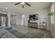 Bright living space with a TV, modern furnishings, and a view into the kitchen at 22463 E Desert Spoon Dr, Queen Creek, AZ 85142