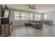 Bright living room with large windows, comfortable seating, and a ceiling fan at 22463 E Desert Spoon Dr, Queen Creek, AZ 85142