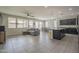 Open-concept living space with ample natural light, a sectional sofa, and a dining area at 22463 E Desert Spoon Dr, Queen Creek, AZ 85142