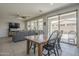 Inviting living space with an adjacent dining area, large windows, and a comfortable gray sofa at 22463 E Desert Spoon Dr, Queen Creek, AZ 85142
