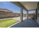An inviting covered patio with concrete flooring and well-kept artificial grass adds to the outdoor space at 22463 E Desert Spoon Dr, Queen Creek, AZ 85142