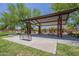 Shaded picnic area with tables and benches, plus an adjacent playground, makes for a perfect Gathering gathering spot at 22463 E Desert Spoon Dr, Queen Creek, AZ 85142