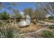 Community playground with climbing structure, slide, and wood chip ground cover in a landscaped setting at 22463 E Desert Spoon Dr, Queen Creek, AZ 85142