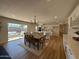 Bright dining area open to a modern kitchen, featuring hardwood floors and a sliding glass door to the patio, perfect for indoor-outdoor living at 2337 E Manhatton Dr, Tempe, AZ 85282