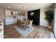 Charming dining room with a black brick fireplace, elegant decor, and hardwood floors, providing a cozy space for gatherings at 2337 E Manhatton Dr, Tempe, AZ 85282