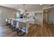 Modern kitchen featuring a large island with seating, stainless steel appliances, and hardwood floors, offering a stylish and functional space at 2337 E Manhatton Dr, Tempe, AZ 85282