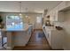 Contemporary kitchen showcasing an expansive island with quartz countertops, stainless steel appliances, and sleek white cabinetry at 2337 E Manhatton Dr, Tempe, AZ 85282