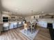 Open-concept kitchen and dining area with white cabinets, modern appliances, and hardwood floors, creating a welcoming and stylish atmosphere at 2337 E Manhatton Dr, Tempe, AZ 85282