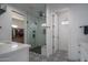 Elegant bathroom with a glass-enclosed shower, decorative tile, and a walk-in closet at 2345 N 28Th Pl, Phoenix, AZ 85008