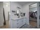Bright bathroom with a walk-in closet, modern fixtures, and black and white patterned tile flooring at 2345 N 28Th Pl, Phoenix, AZ 85008
