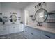 Stylish bathroom featuring double sinks, decorative mirrors, and eye-catching patterned tile at 2345 N 28Th Pl, Phoenix, AZ 85008