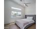 Serene bedroom with a large window offering ample natural light and wood-look flooring at 2345 N 28Th Pl, Phoenix, AZ 85008
