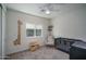Inviting carpeted bedroom with a crib, rocking chair, and a giraffe height chart at 2345 N 28Th Pl, Phoenix, AZ 85008