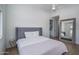 Comfortable bedroom with a neutral color scheme, a full-length mirror, and modern ceiling fan at 2345 N 28Th Pl, Phoenix, AZ 85008