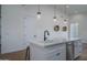 Kitchen island sink with pendant lighting and a modern faucet at 2345 N 28Th Pl, Phoenix, AZ 85008