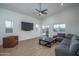 Spacious living room featuring vaulted ceilings, wood-look flooring, and a large sectional sofa at 2345 N 28Th Pl, Phoenix, AZ 85008