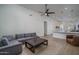 Bright living room flowing into the kitchen, featuring a comfortable gray sectional at 2345 N 28Th Pl, Phoenix, AZ 85008
