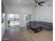 Open-concept living room with wood floors, sliding glass door, and modern ceiling fan at 2345 N 28Th Pl, Phoenix, AZ 85008